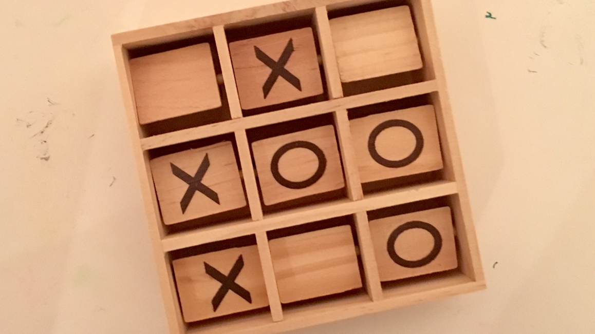 Wooden tic tac toe game from above.
