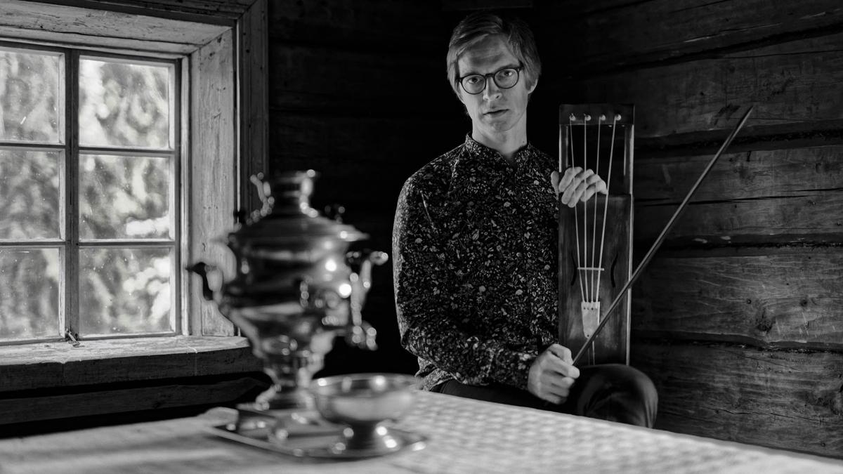 Ilkka Heinonen sits behind cottage table.