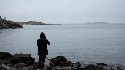 Person on Kuninkaansaari shore looking over the sea