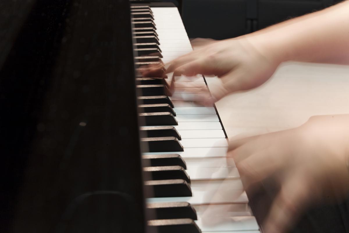 Fingers on piano keyboards