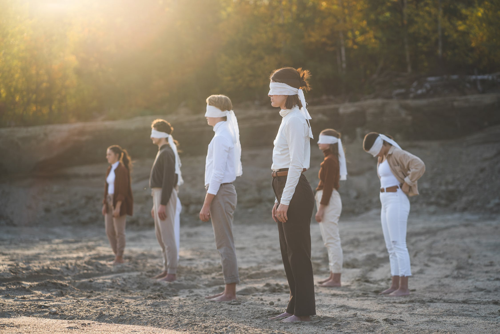 People standing on the peach blindfolded.