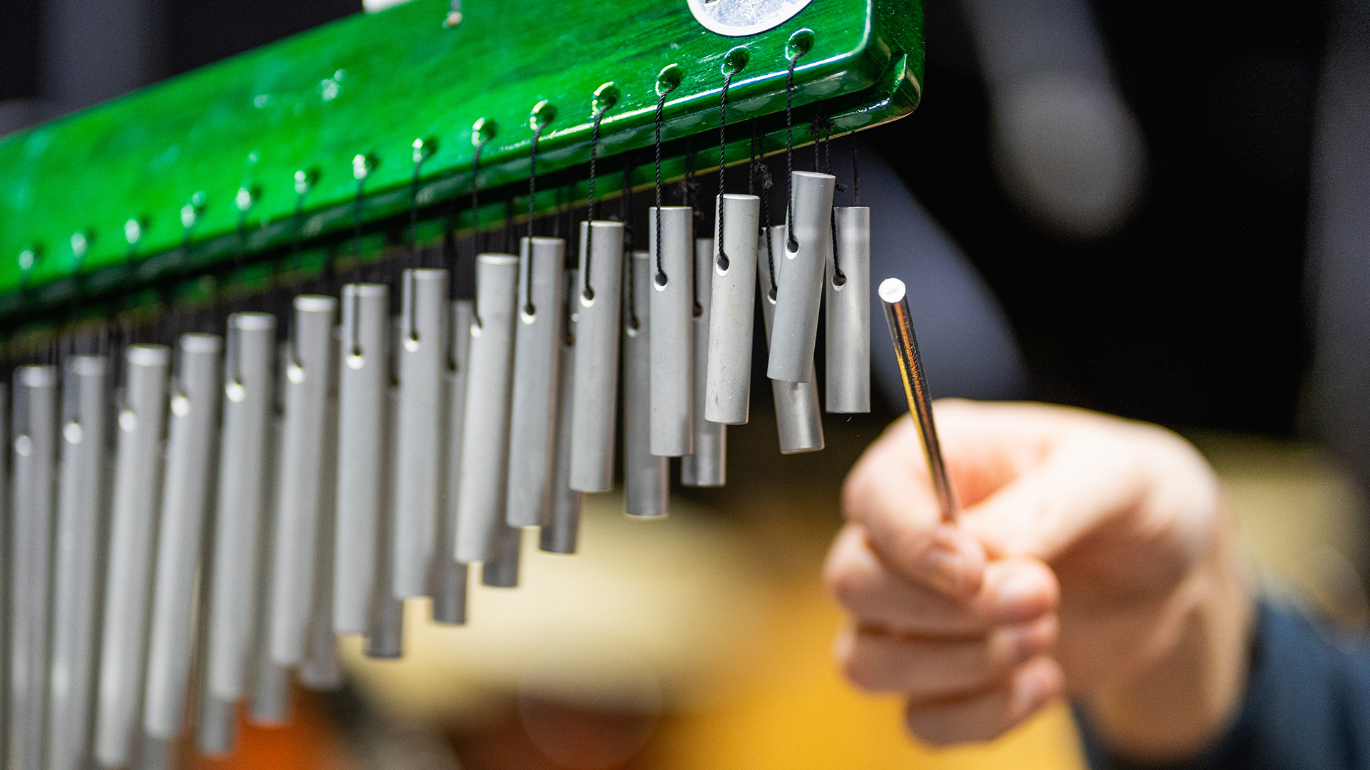 A hand playing an instrument