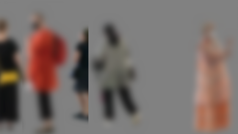 Unfocused human figures on a grey background