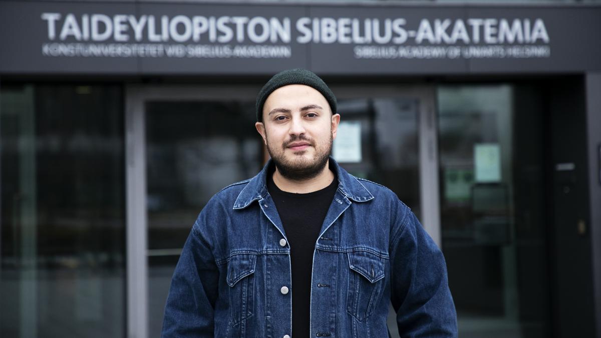 Young man in front of the university doors