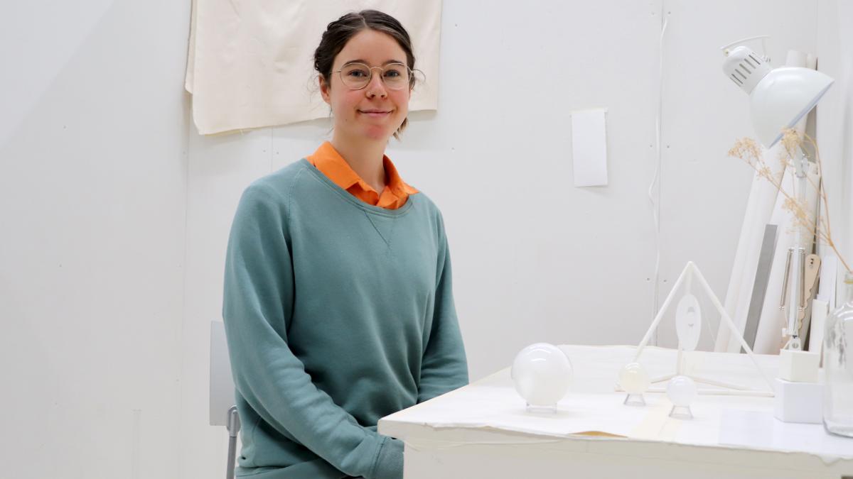 Student sits at her art studio