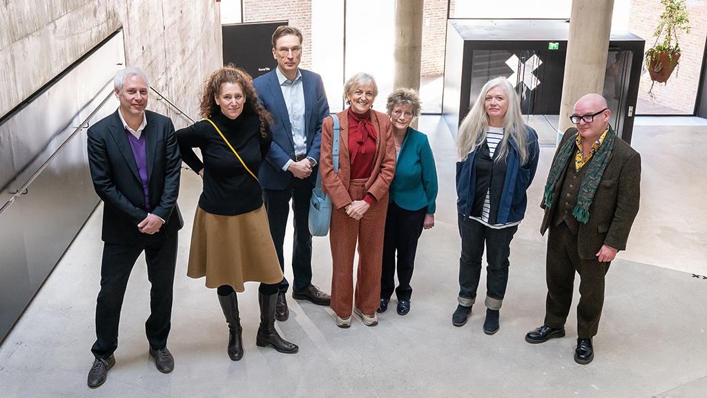 The international assessment panel poses in the staircase in Mylly building.