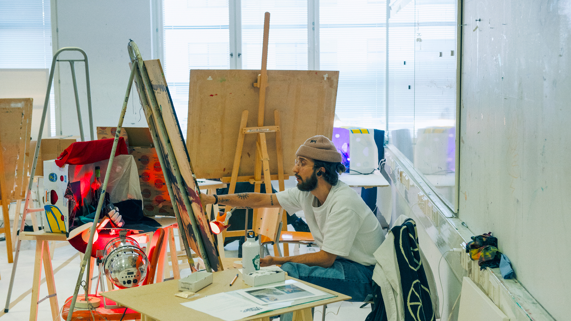 Student painting in a studio