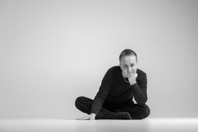 Francis Maskens sits in a dance studio.