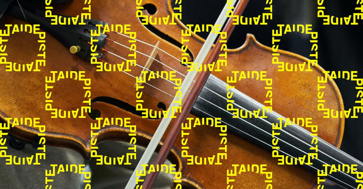 Photo of a violin with Taidepiste logos on it