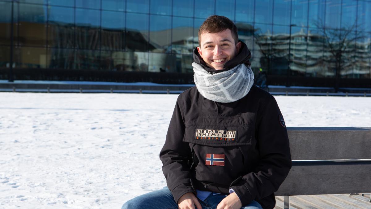 Exchange student Pablo Gill sits in front of the Music Centre in Helsinki.